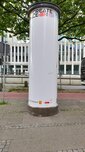 Die Litfaßsäule vor dem Beschreiben ist weiß mit blauen Linien.